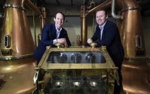 Brothers Stephen and Jack Teeling and the brass spirit safe that holds the first whiskey spirit to be produced in Dublin in almost four decades. © Patrick Bolger Photography