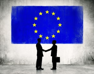 Two Business Person Shaking Hands with the European Union Flag